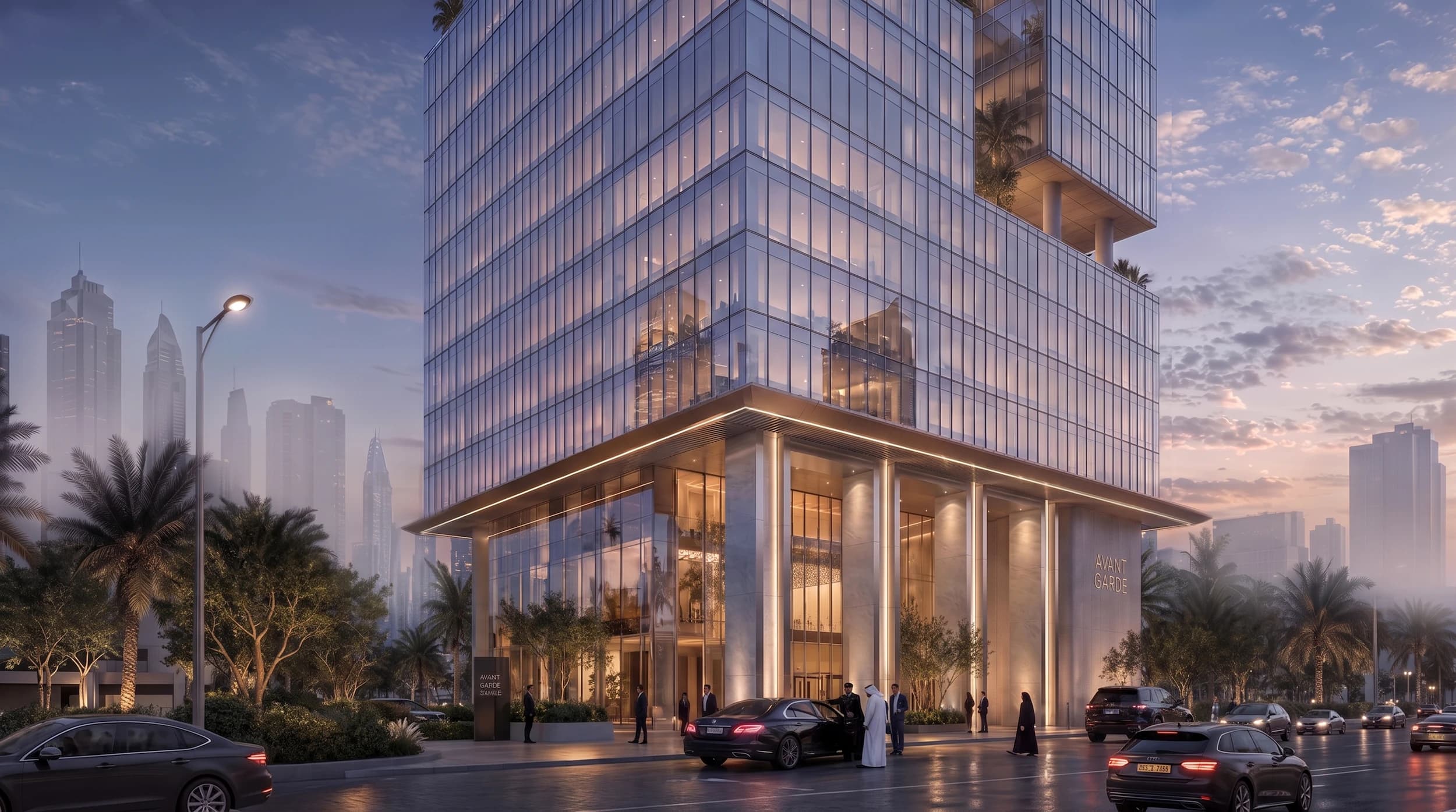 Base of the glass tower with a colonnaded entrance and landscaped street frontage at dusk