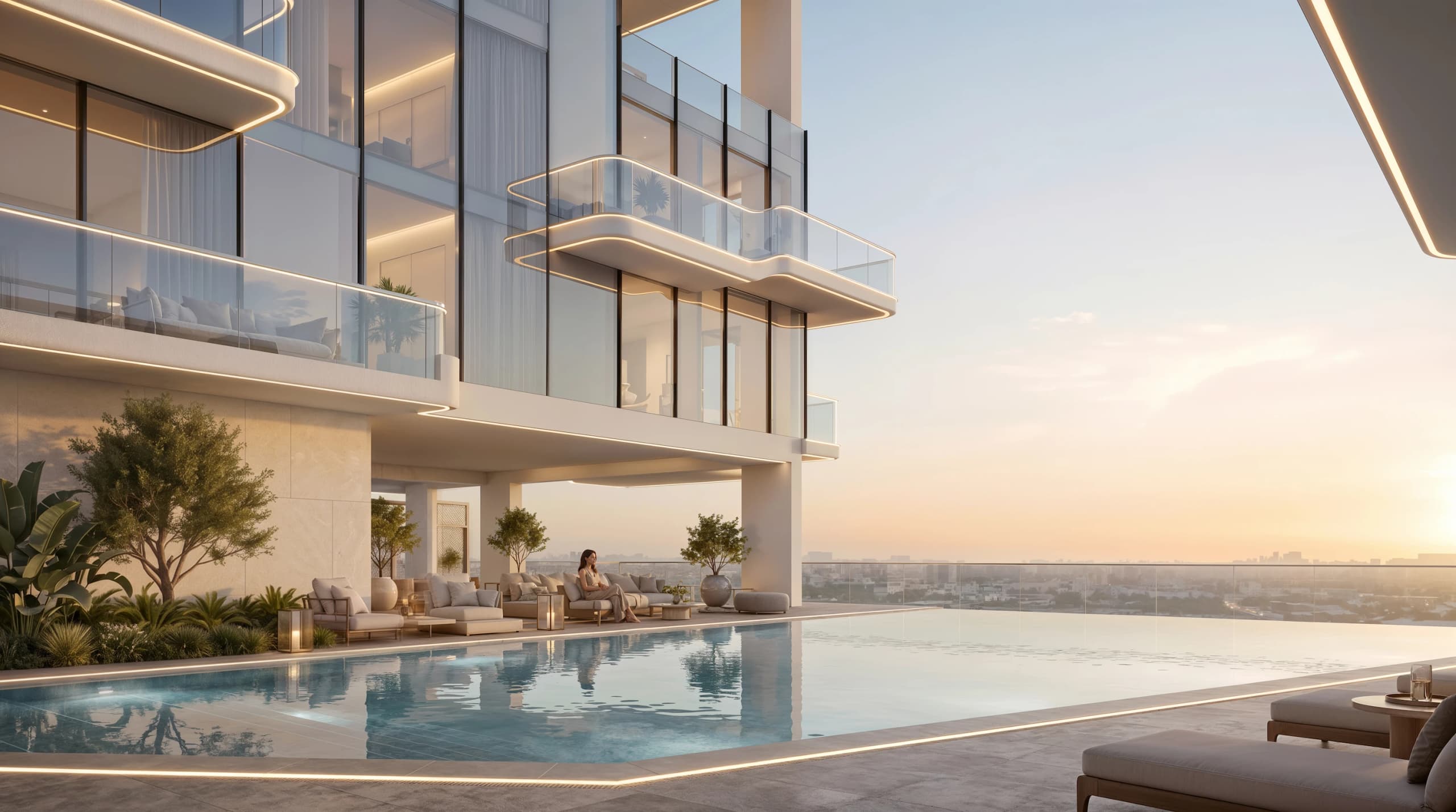 Infinity pool terrace beside glass-balconied apartments at sunset