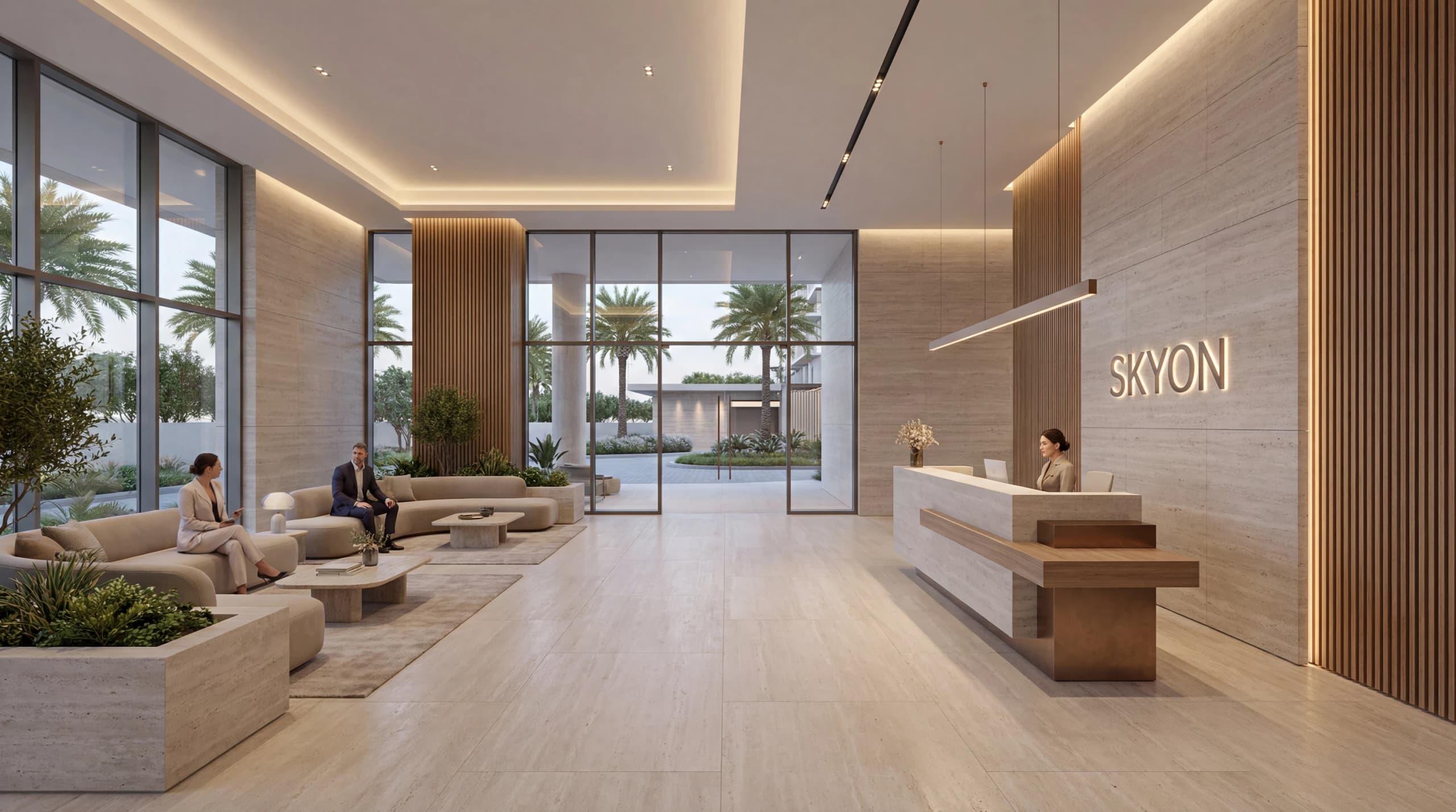 Lobby with a reception desk, lounge seating and the SKYON name on a stone wall